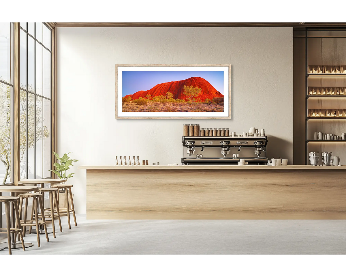 Uluru Awakening. Outback wall art print with a timber frame hung in a cafe. 
