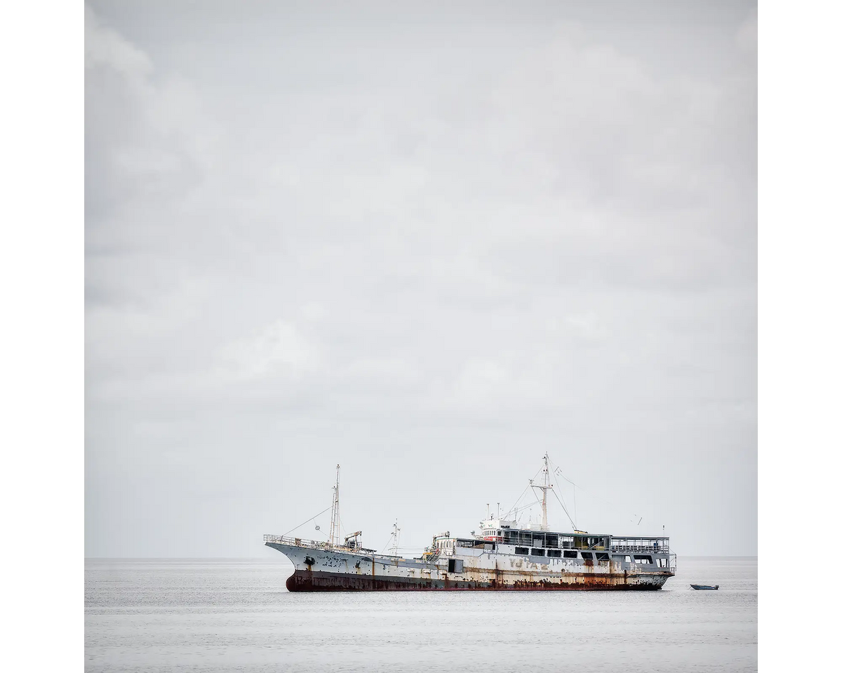 Uncertainty. Old boat on floating on water in Honiara, Soloman Island.