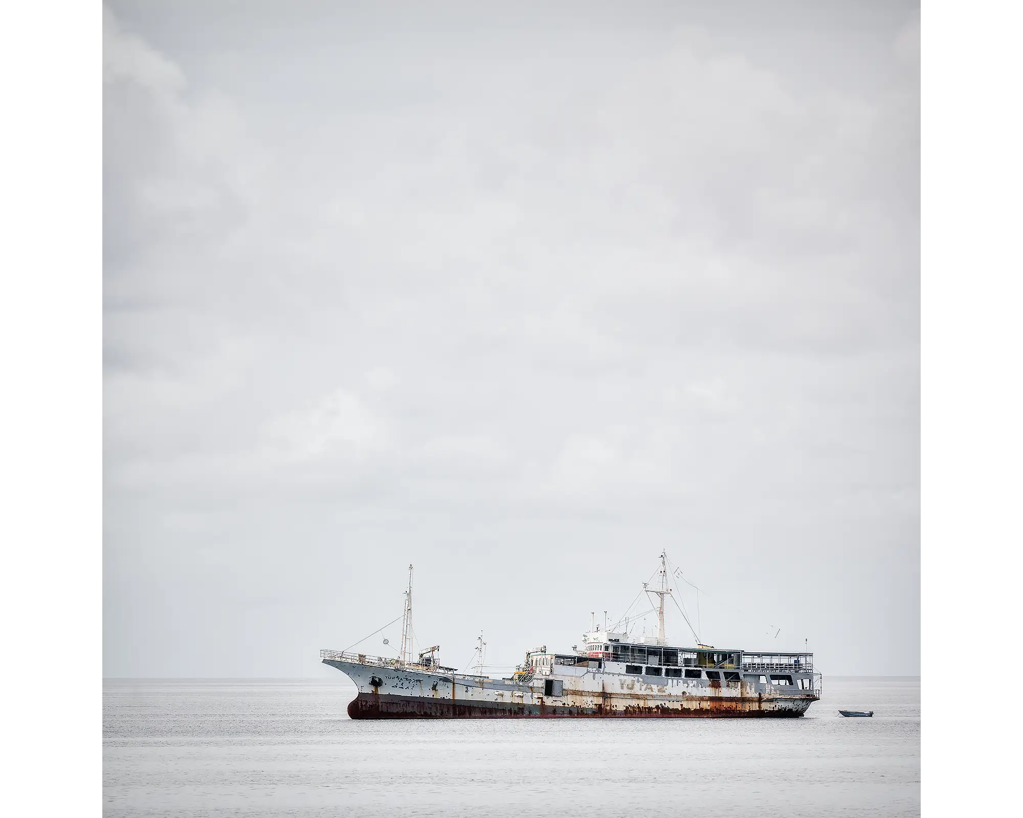 Uncertainty. Old boat on floating on water in Honiara, Soloman Island.