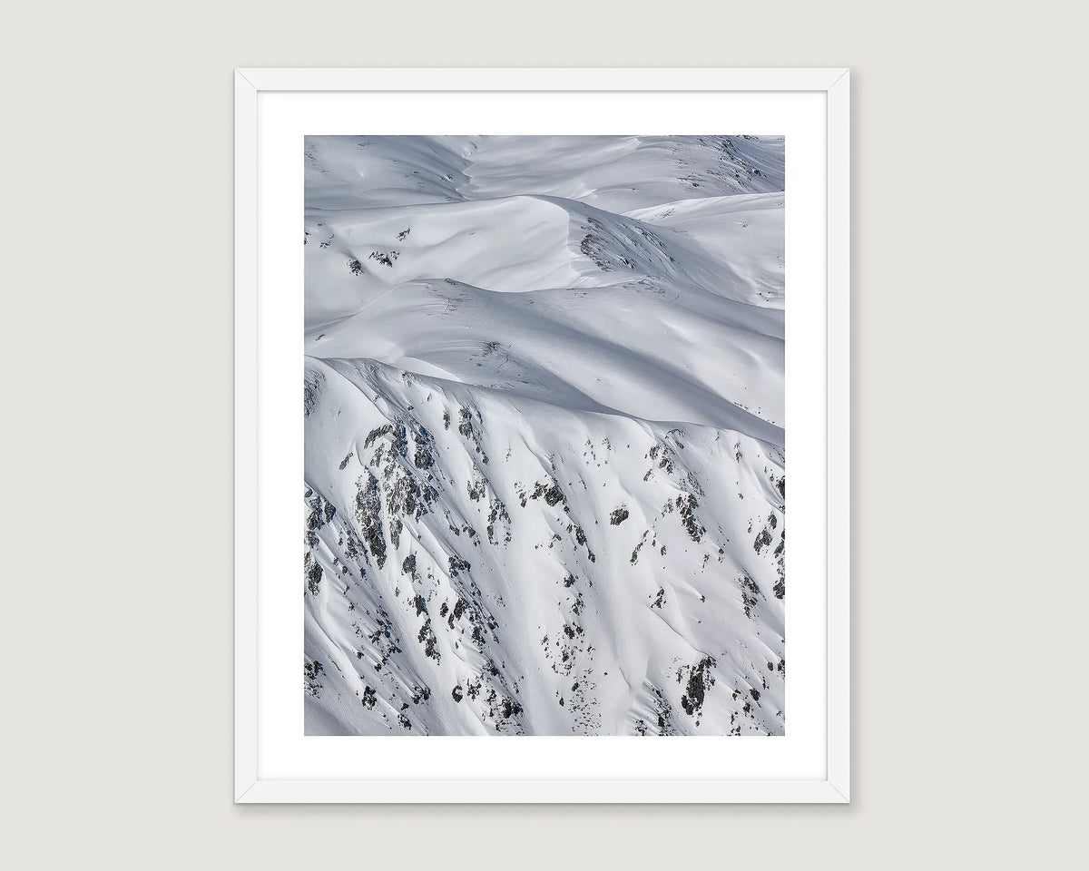 Framed abstract artwork of a snowy mountainous landscape.