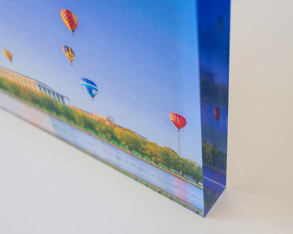 Upwards. Acrylic block of hot air balloons over the National Library of Australia, corner close-up image.