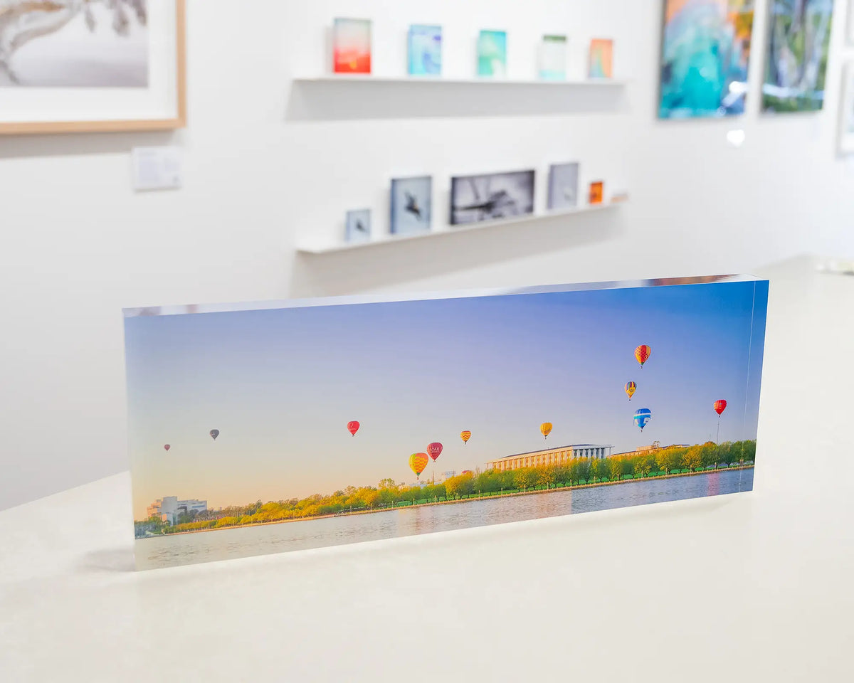 Upwards. Acrylic block of hot air balloons over the National Library of Australia, in the gallery space.