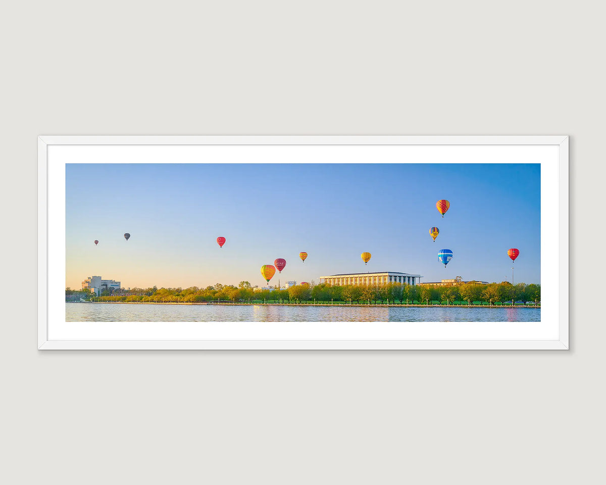 Framed artwork of hot air balloons over Lake Burley Griffin with buildings in the background.