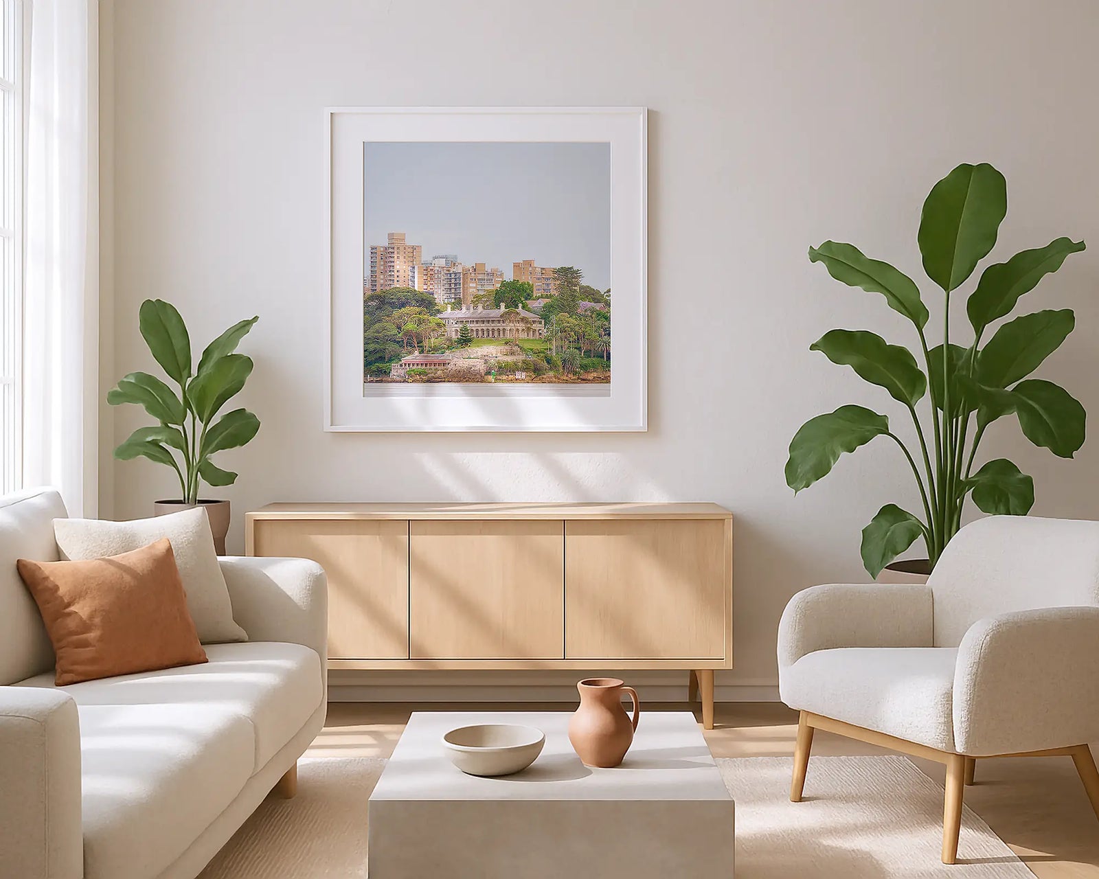 Framed photograph of Admiralty House and a cityscape with buildings and greenery.