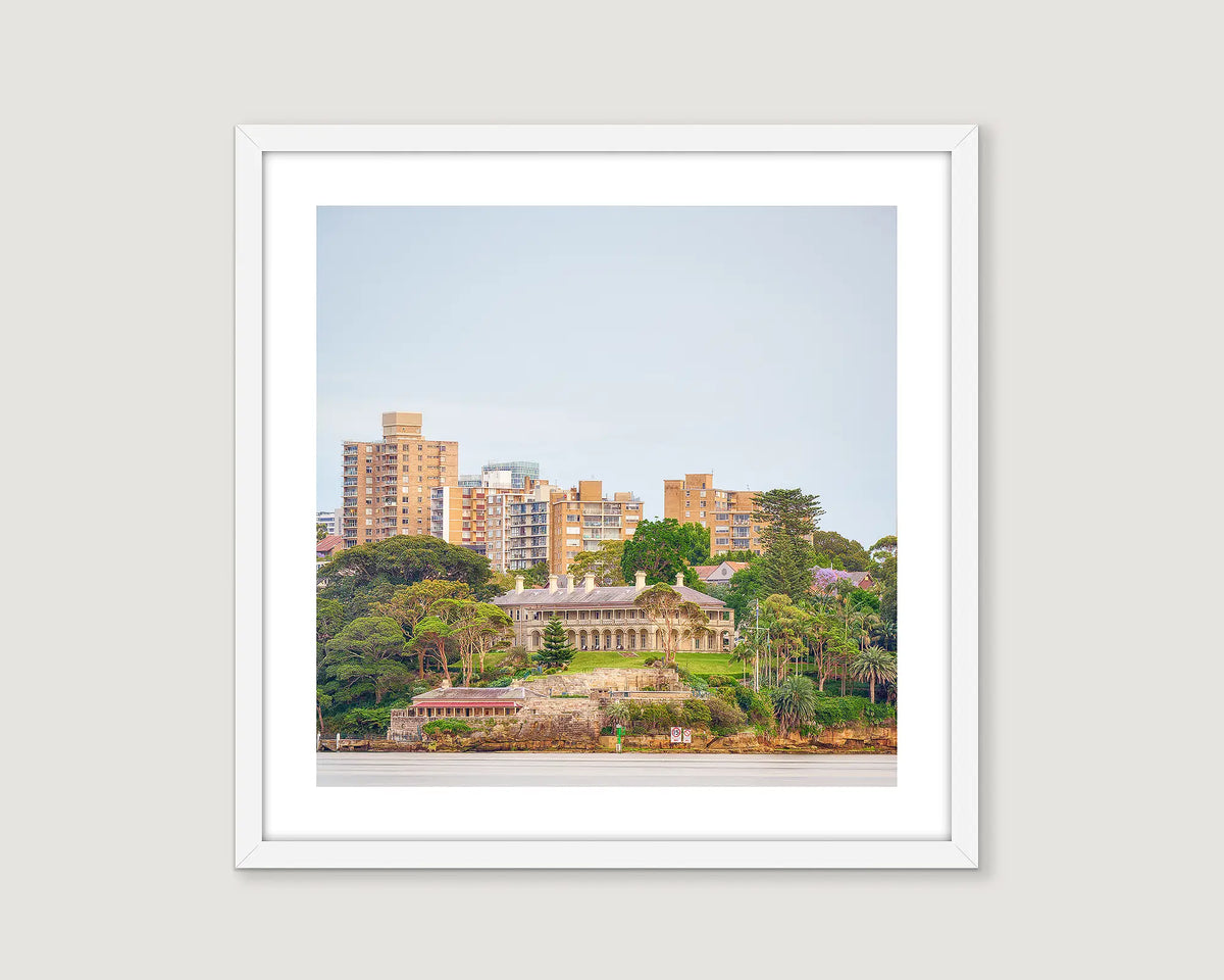 Framed photograph of Admiralty House and a cityscape with buildings and greenery.