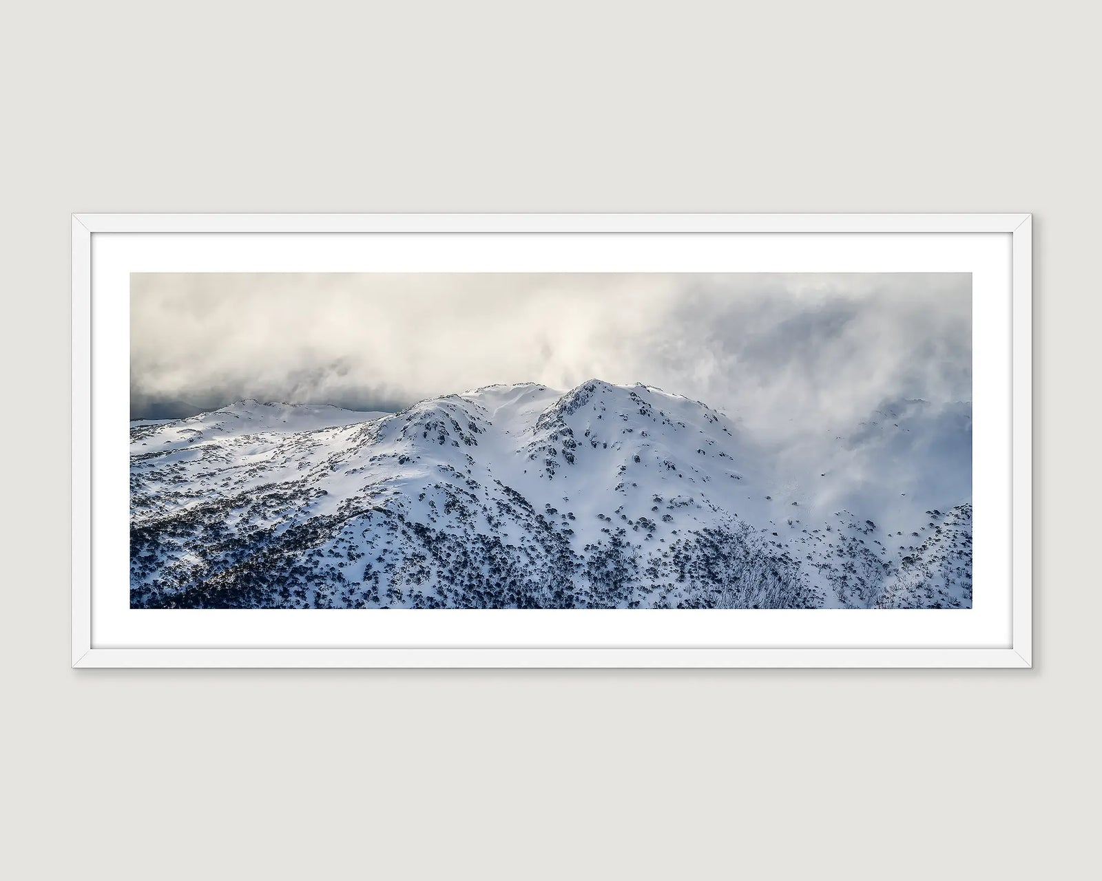 Framed photograph of a mountain landscape at Kosciuszko with snow and clouds.
