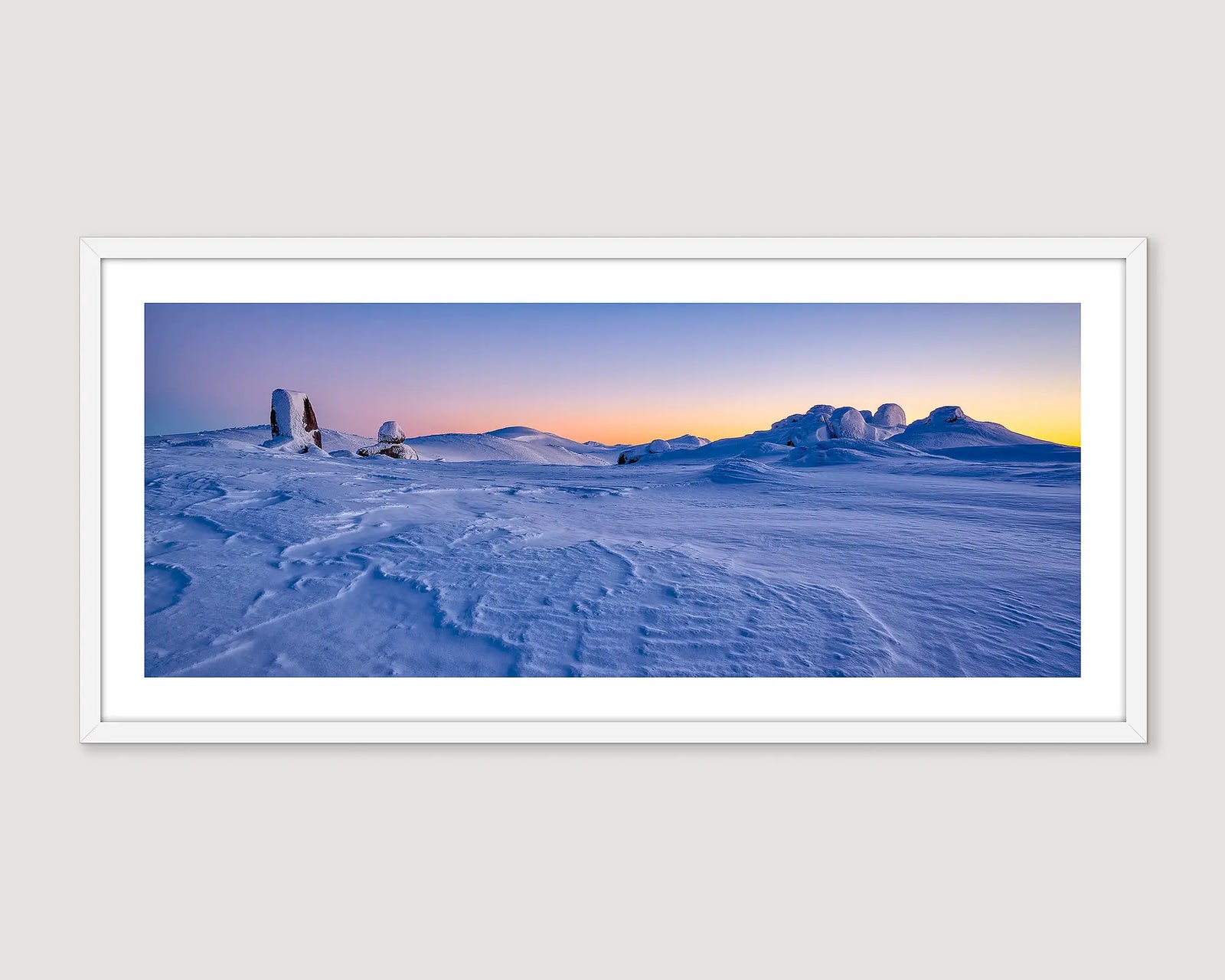 Framed photograph of a snowy Rams Head Range and Main Range landscape with a sunrise.