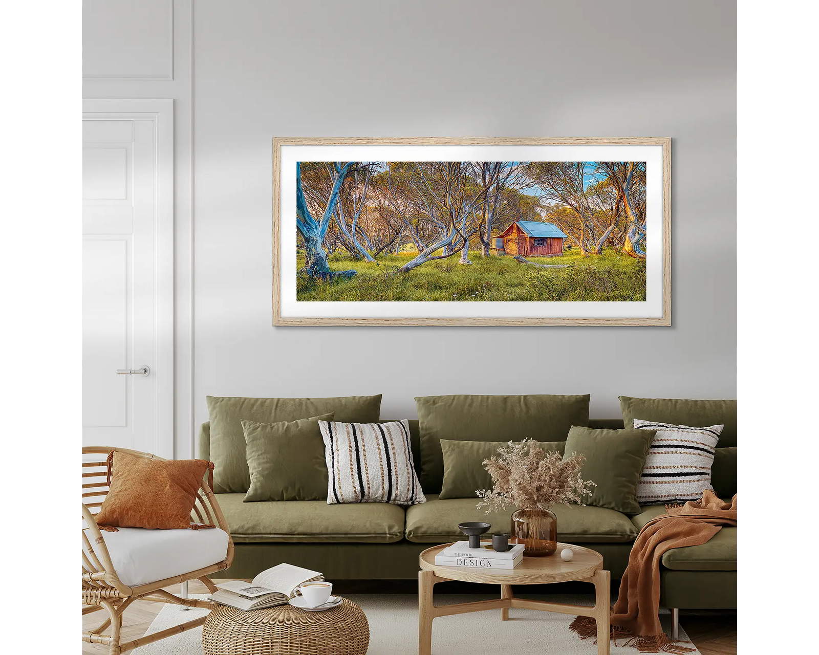 Framed photograph of a rustic JB Hut in the Alpine National Park nestled among trees with a white frame.