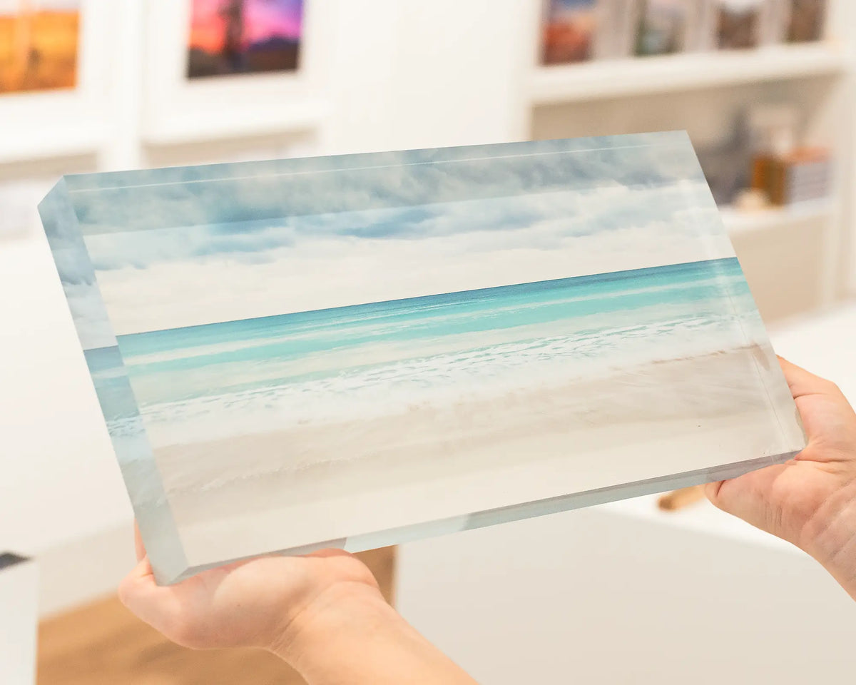 Washed coastal artwork. 36cm acrylic block being held in hand.