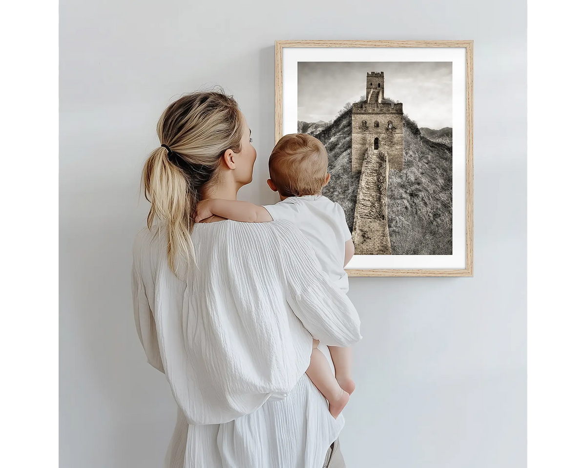 Watchtowers. Photography artwork of the Great Wall of China with a timber frame, being admired by a mother and baby. 