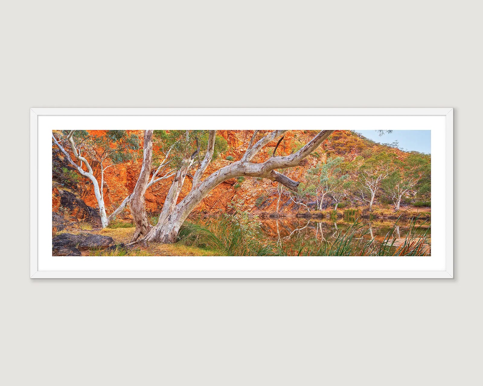 Framed artwork of a scenic Ellery Creek Big Hole, Tjoritja West MacDonnell with trees and red rock formations.