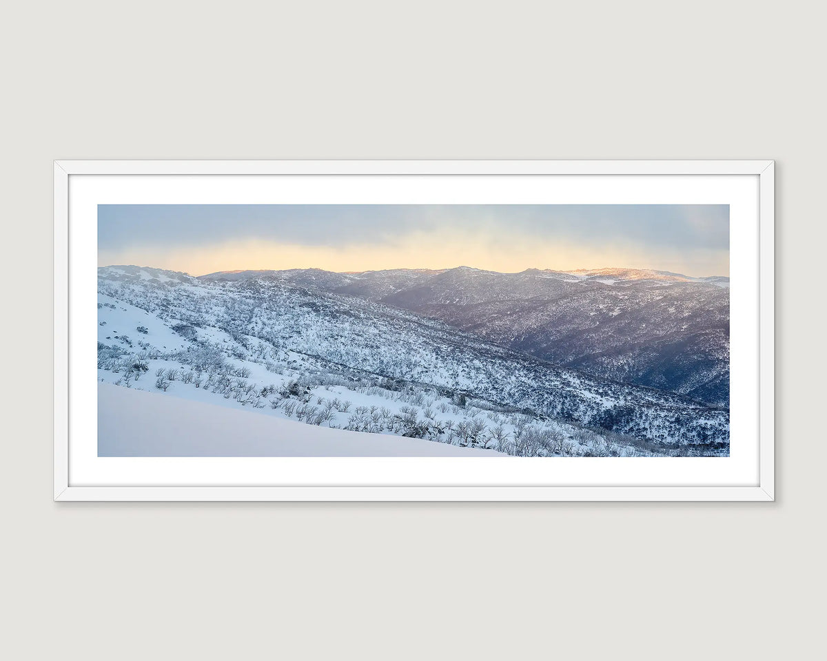 Framed photograph of a snowy mountain landscape, Thredbo Valley, with a soft gradient sky.