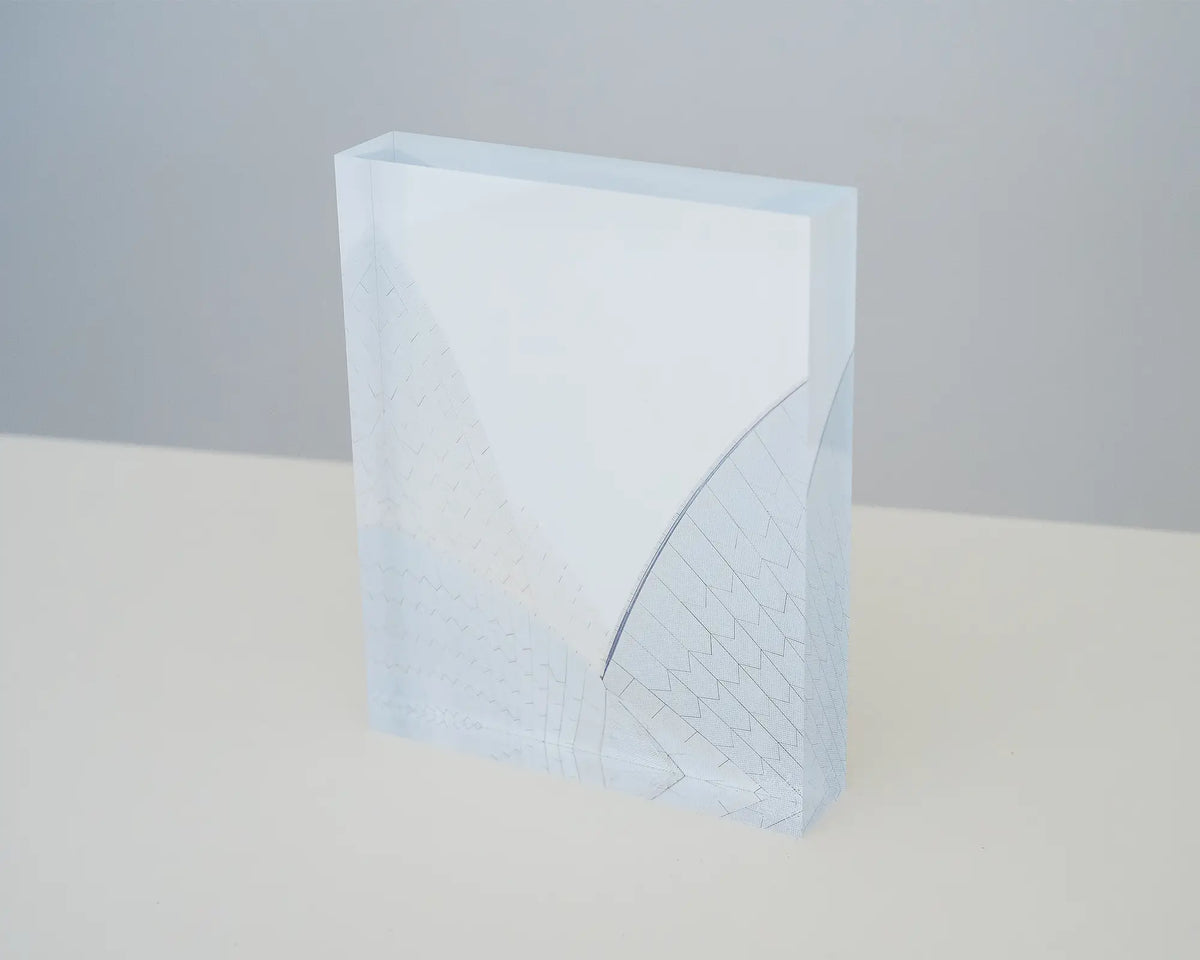 White On White. Acrylic block of Opera House shells on desk.