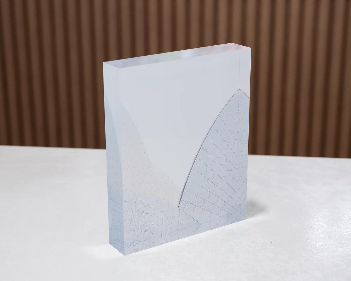 White On White. Acrylic block of the Sydney Opera House shells, sitting on desk.