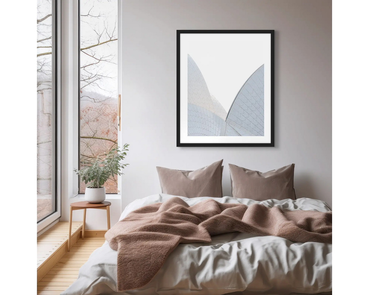 White on White. Sydney Opera House photographic wall art print, with a black frame, hung on a scandi bedroom wall. 