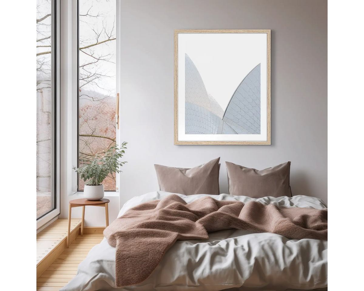 White on White. Sydney Opera House photographic wall art print, with a timber frame, hung on a scandi bedroom wall. 