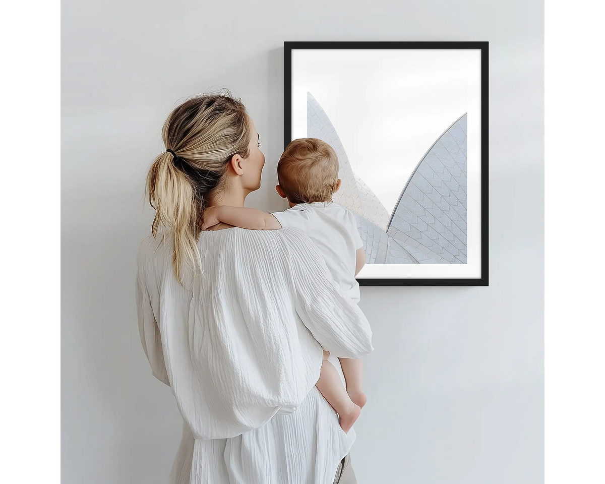 White on White. Sydney Opera House photography artwork with a black frame, being admired by a mother and baby. 