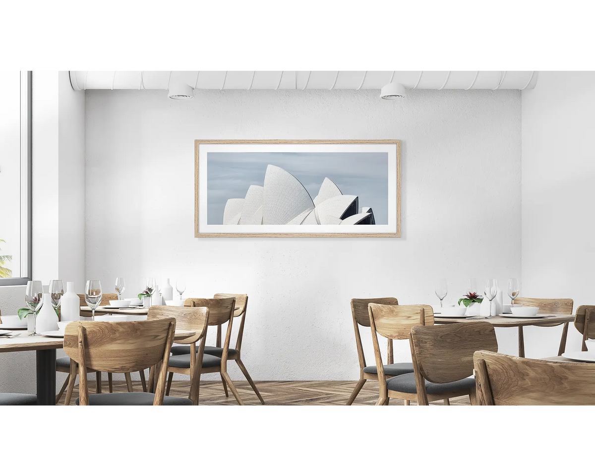 White Sails.  Wall art print with timber frame of the Sydney Opera House hung in a cafe.