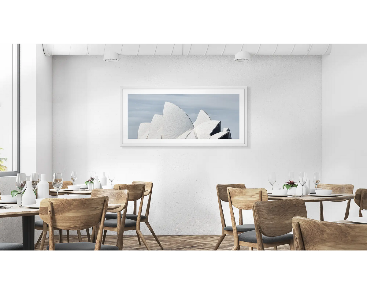 White Sails.  Wall art print with white frame of the Sydney Opera House hung in a cafe.