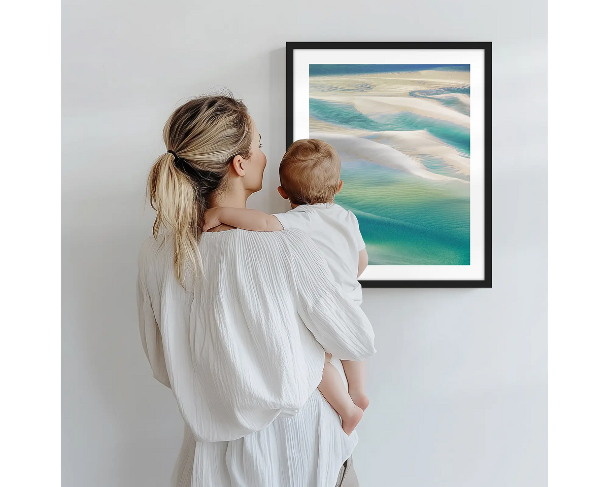 Whitsunday Colours. Aerial photography artwork of Hill Inlet with a black frame, being admired by a mother and baby. 