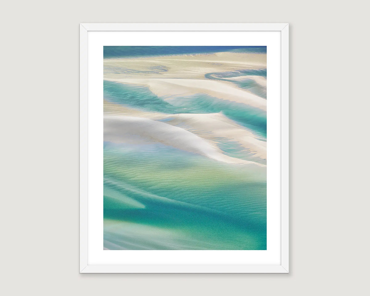 Framed artwork of abstract beach scene with blue and beige tones.
