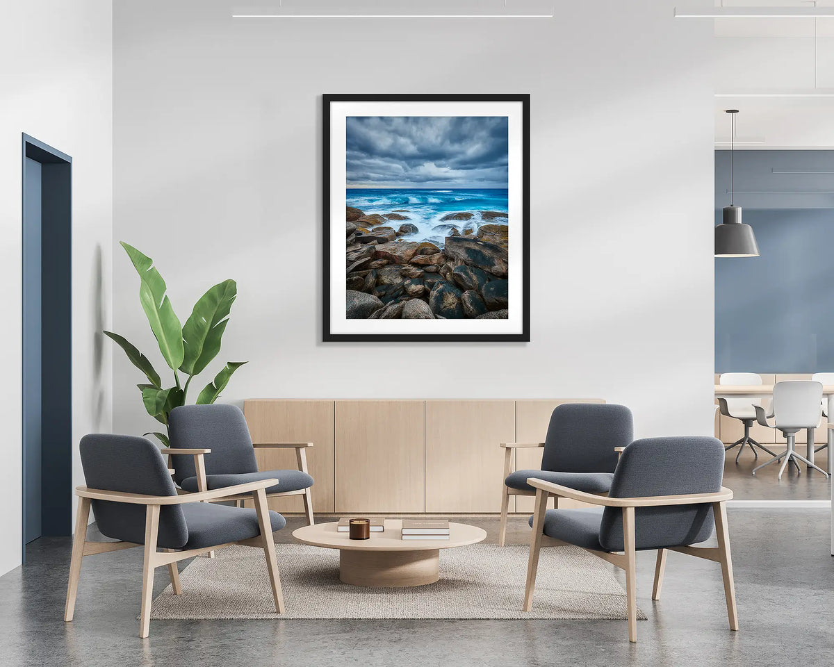 Wild West. Coastal wall art print with a black frame hung in a reception area. 