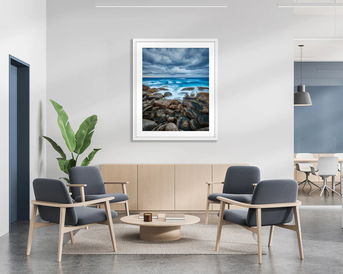 Wild West. Coastal wall art print with a white frame hung in a reception area. 