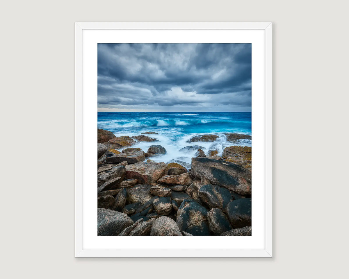 Framed artwork of a rocky coastline in Western Australia with ocean waves and cloudy sky.