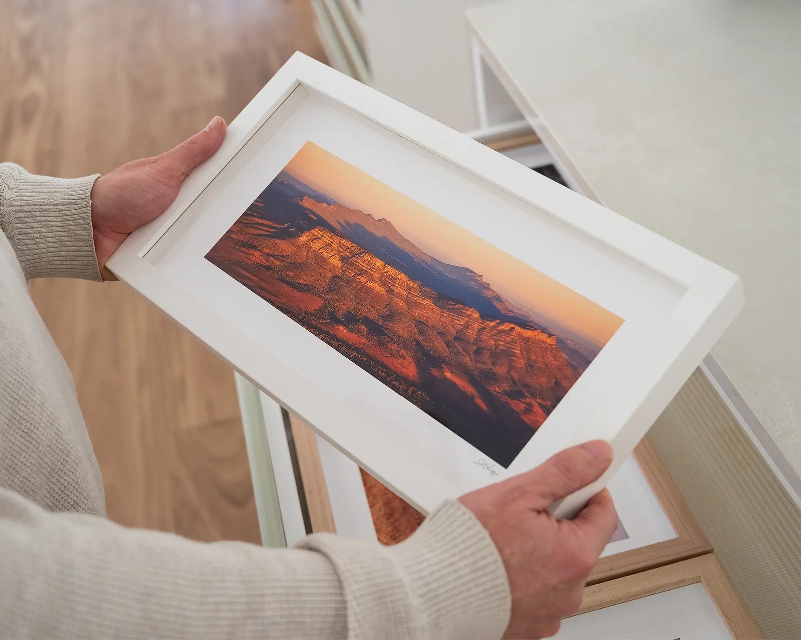 Framed landscape print of a Wilpena Pound desert scene with warm colours.