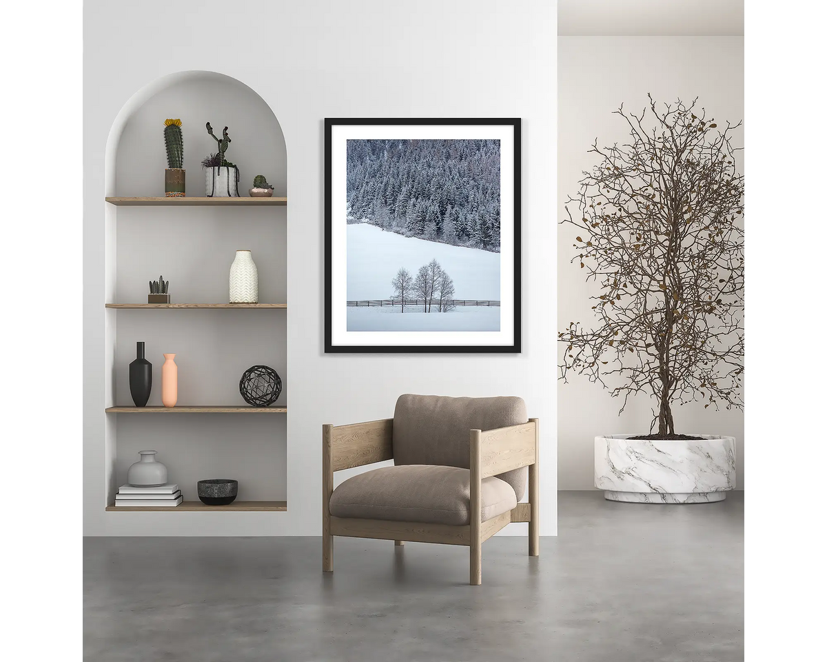 Winter Discovery. Austria wall art print, with a black frame, hung above a chair.