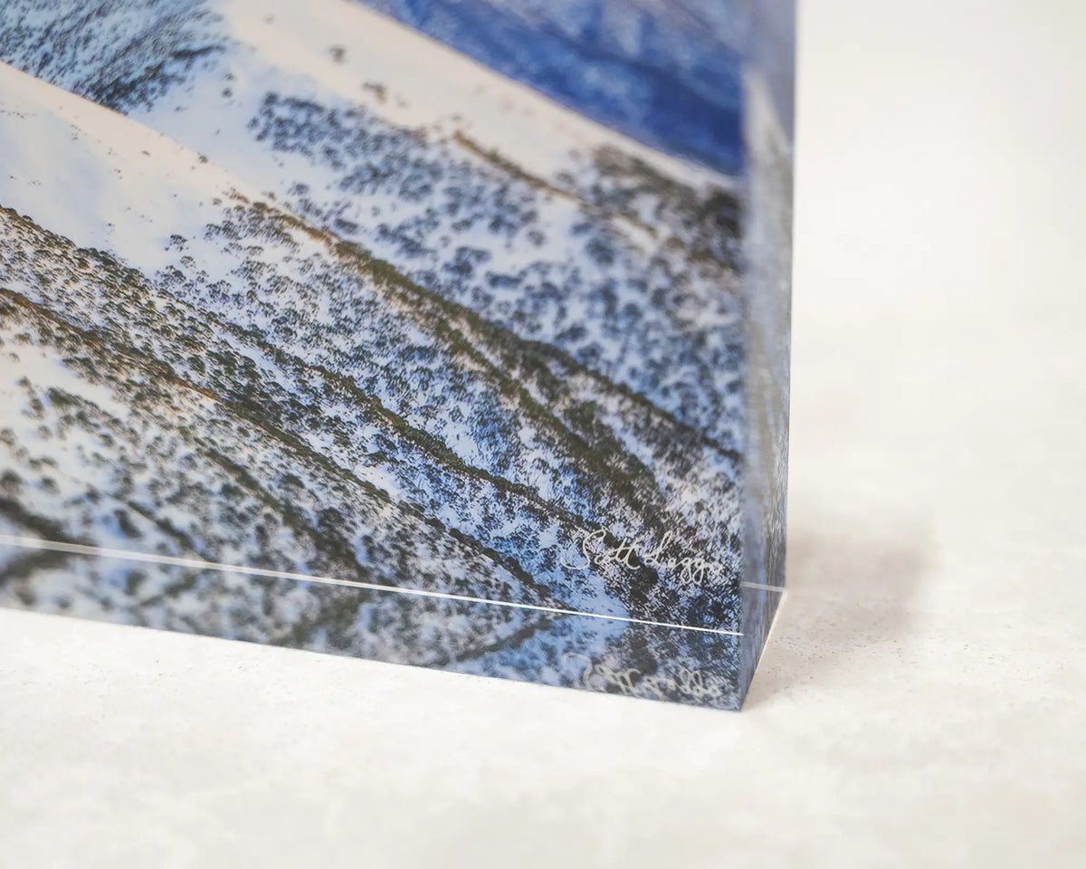 Winter Glow. Acrylic block of an orange sunrise over the summit of Mount Feathertop, close-up corner detail.