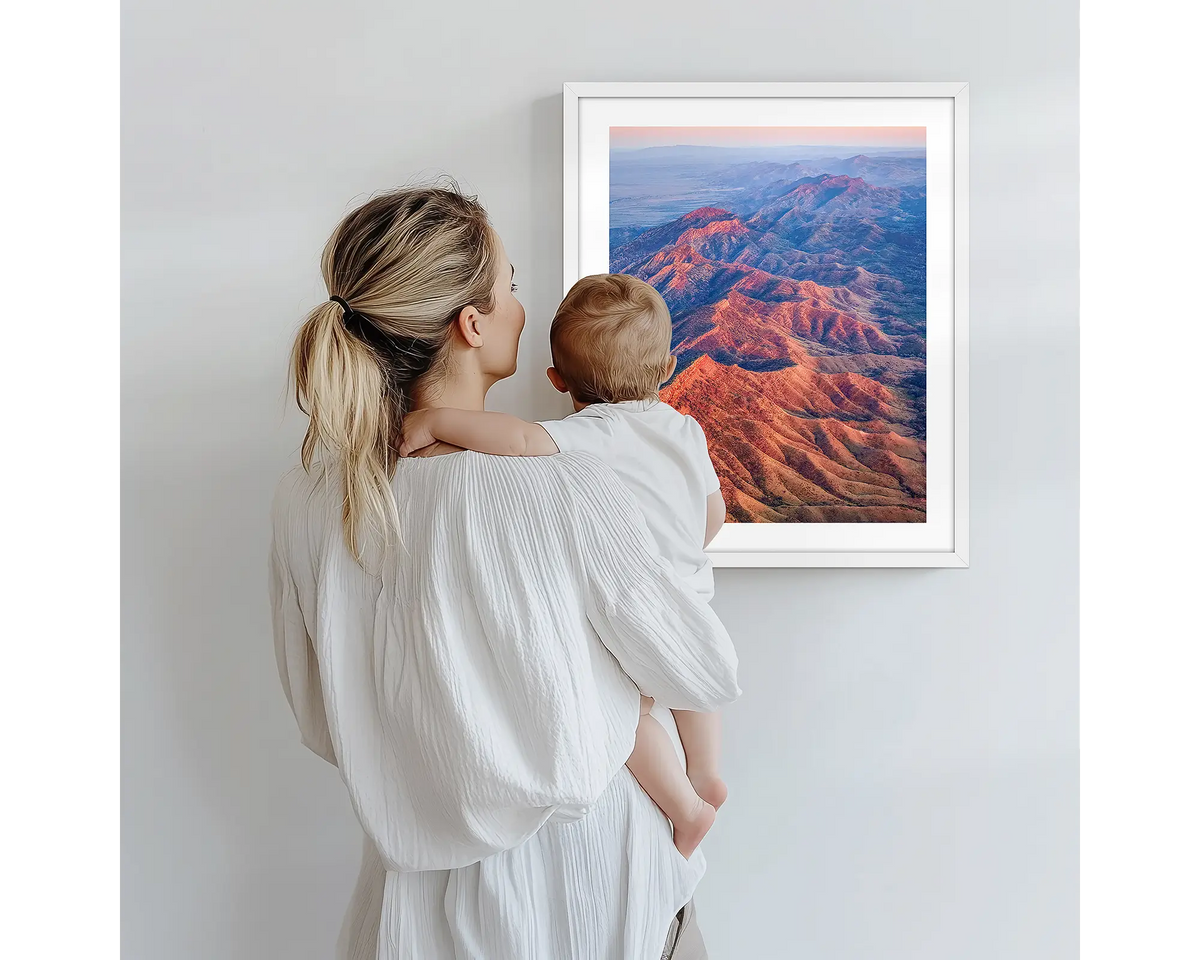 Wrinkles. Aerial photography artwork of Flinders Ranges with a white frame, being admired by a mother and baby. 