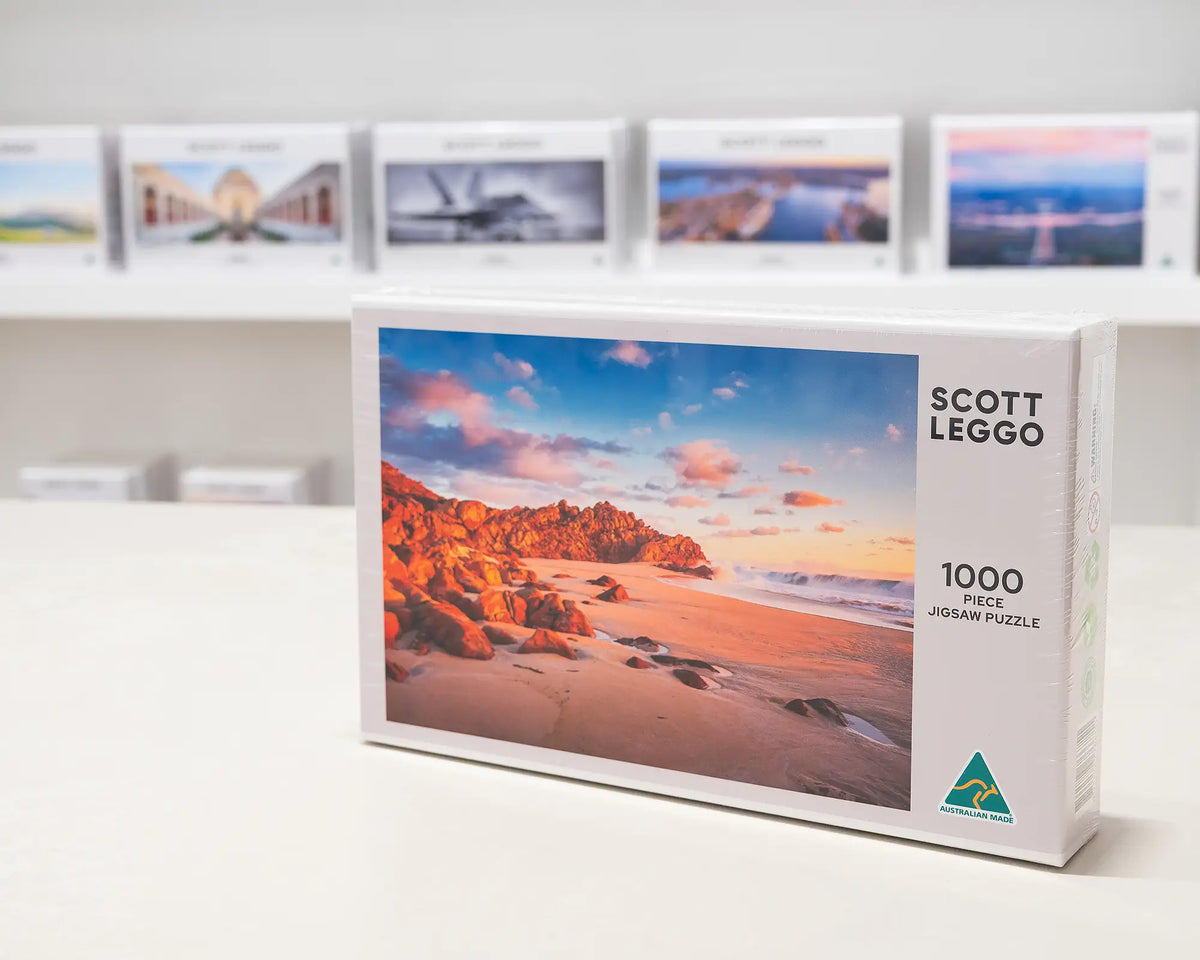 Wyadup Light 1000 piece jigsaw puzzle box sitting on table in front of other puzzles.