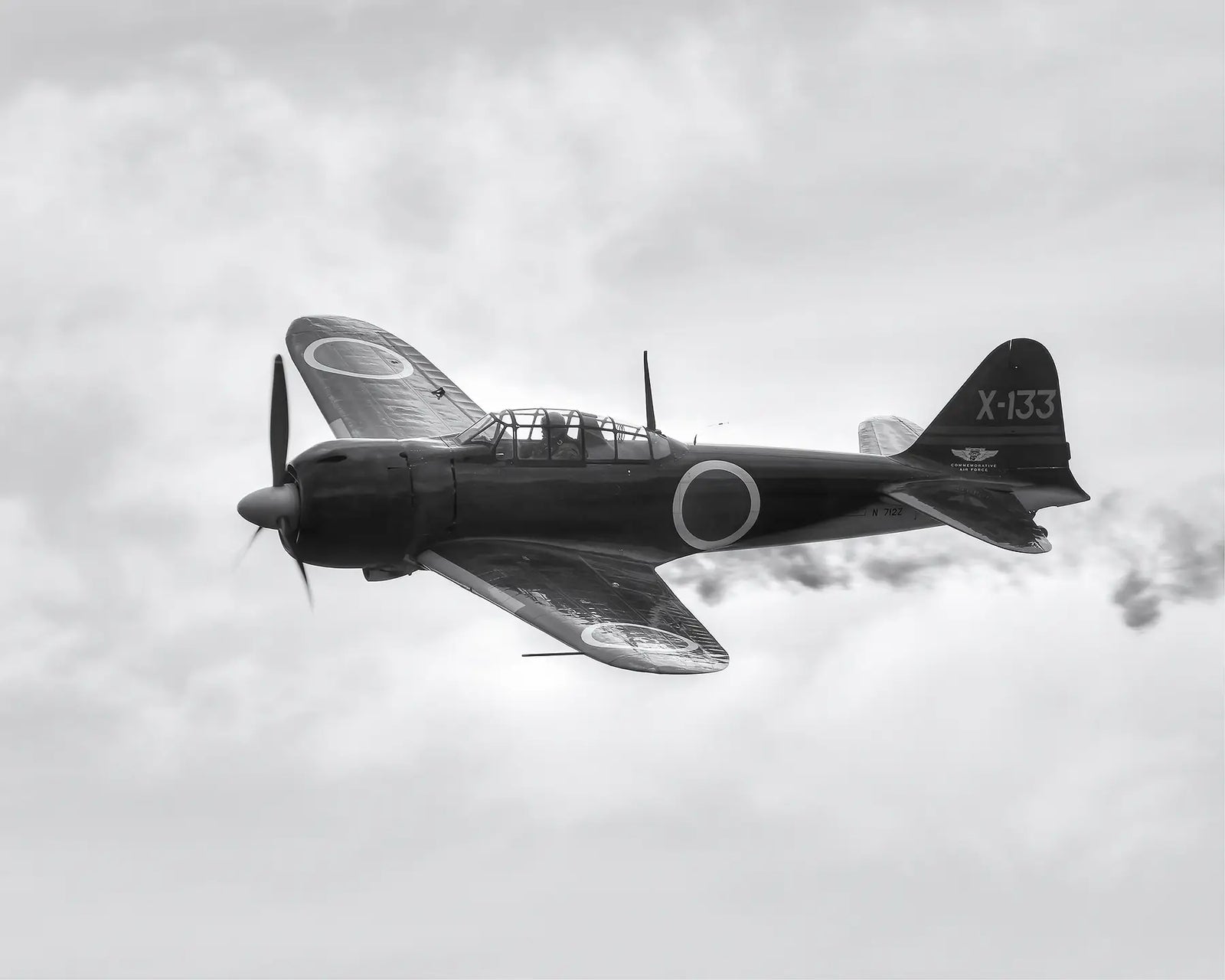 Mitsubishi A6M Zero 'X-133' restored World War II fighter aircraft flying through cloud. 